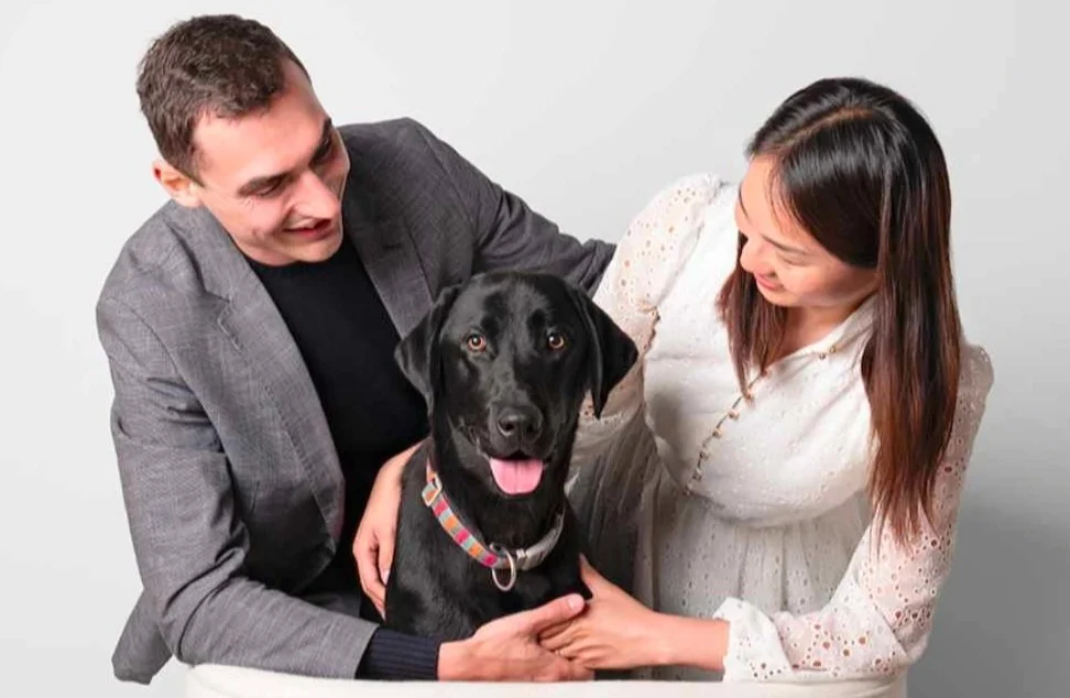 Ally and her husband with their black Labrador, Gulliver