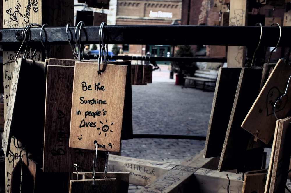 A cafe sign reading “Be the sunshine in people’s lives”