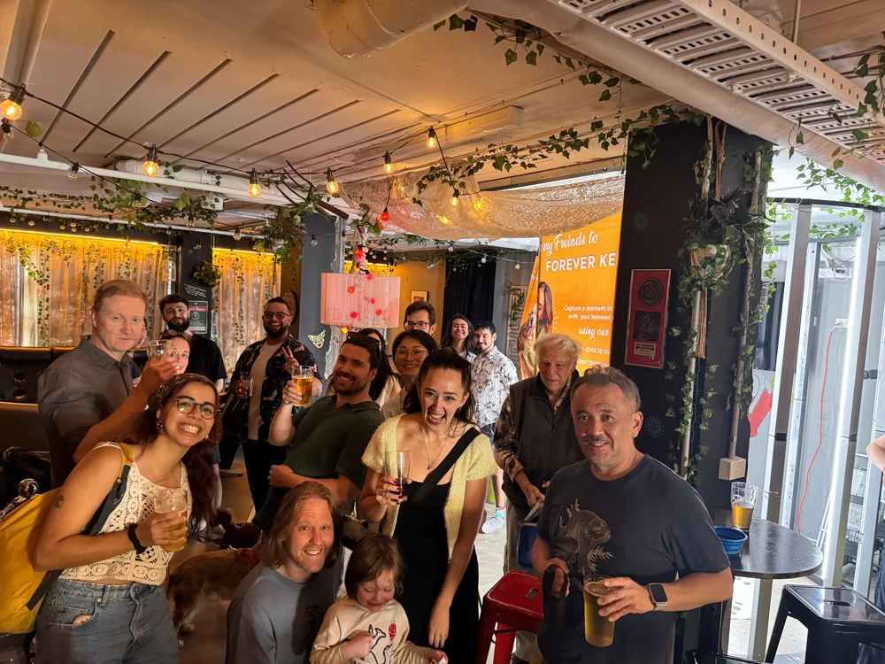 Pawshare Club members raising their glasses together inside a cafe