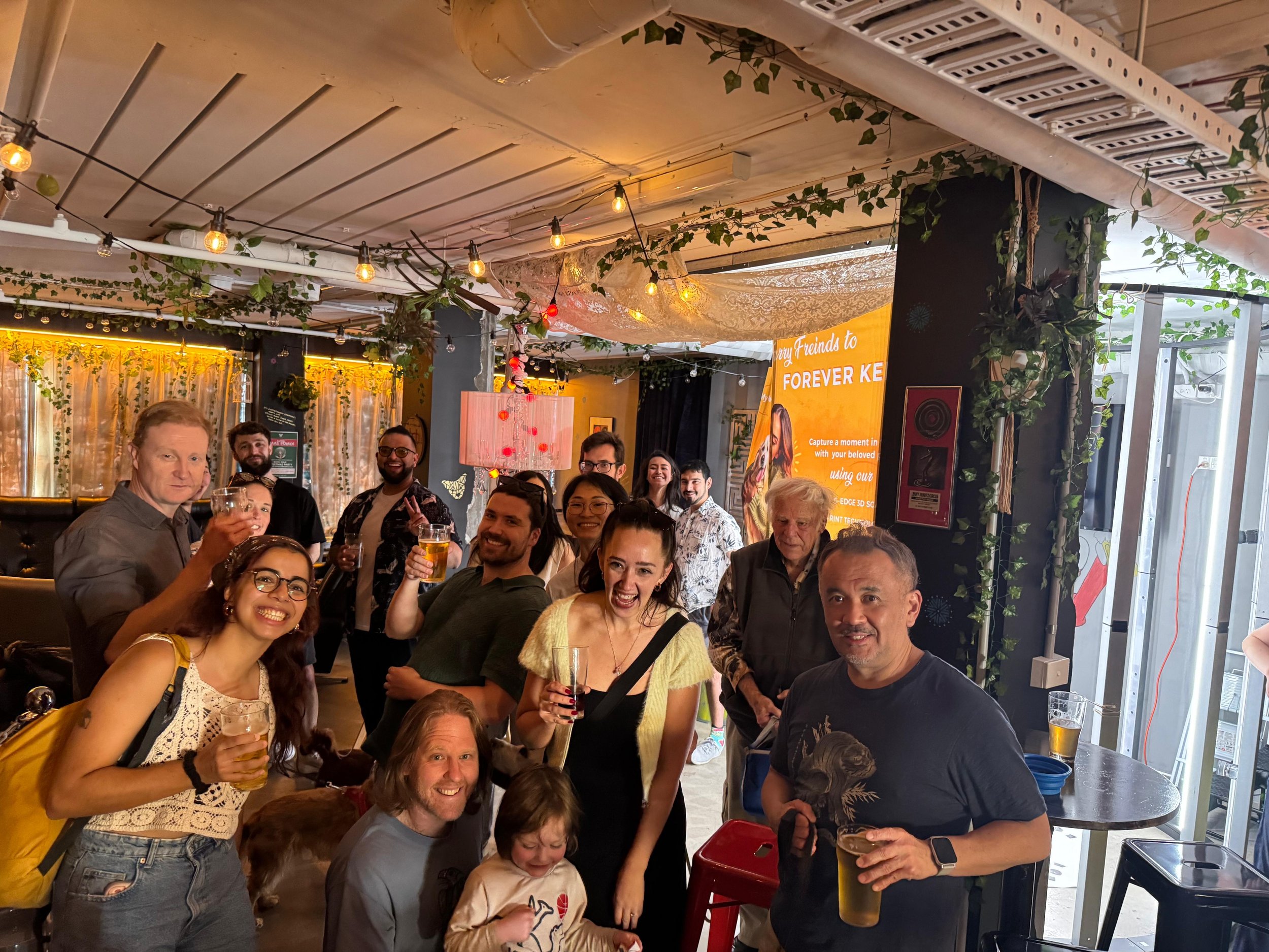 Pawshare Club members raising their glasses together inside a cafe